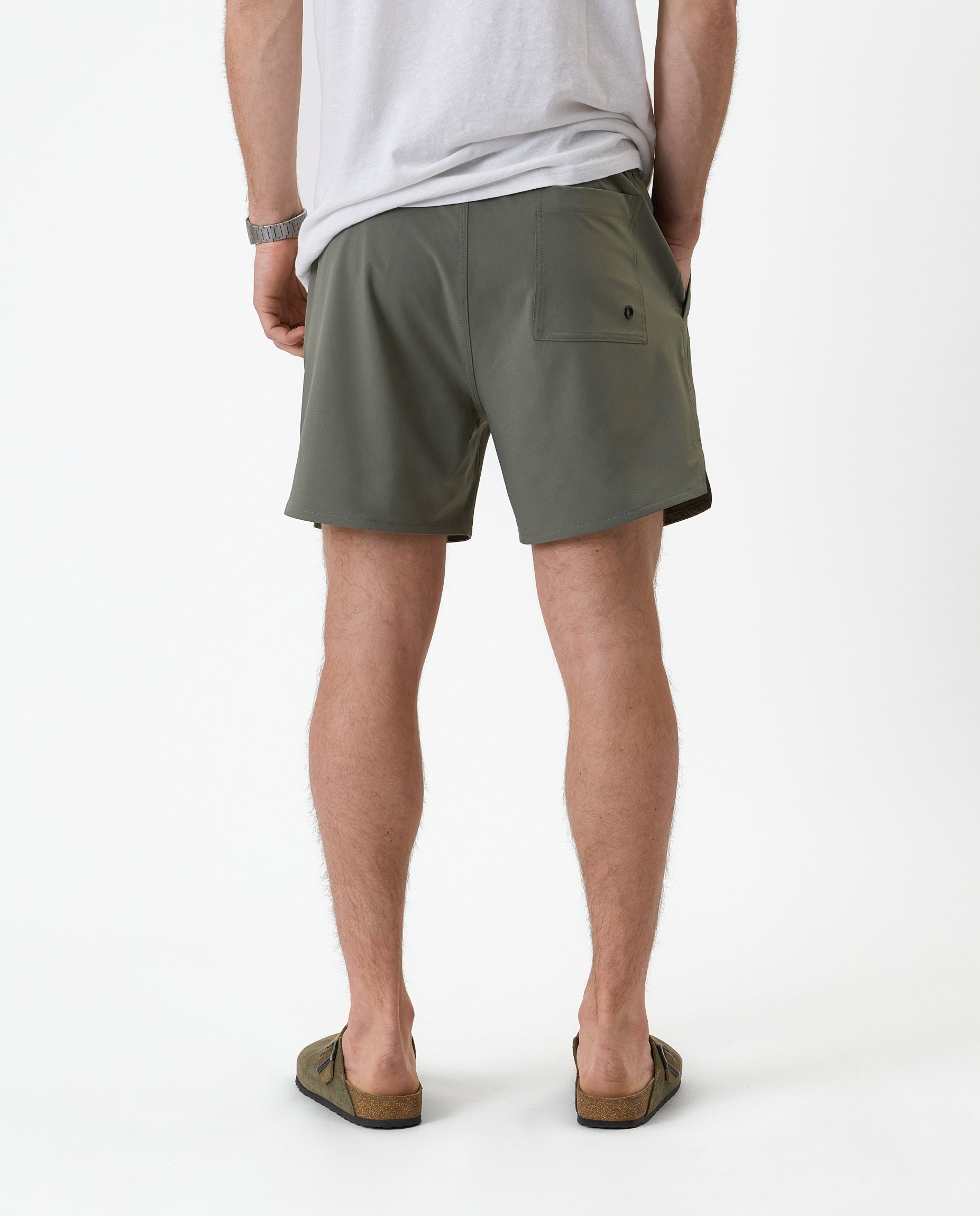 The Shorts in mulled green — back view showing the rear pocket and notched hem