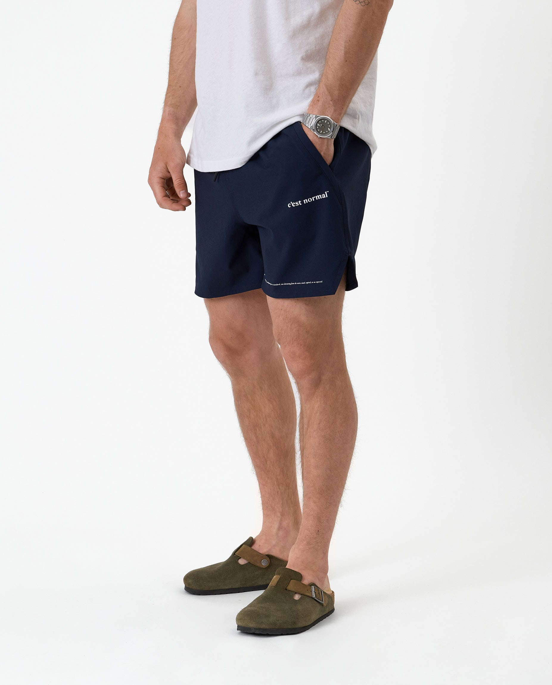 The Shorts in navy — worn with olive clogs and a white t-shirt
