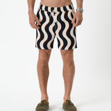 The Shorts in noir curl stripe — front view showing the wavy pattern and orange accents