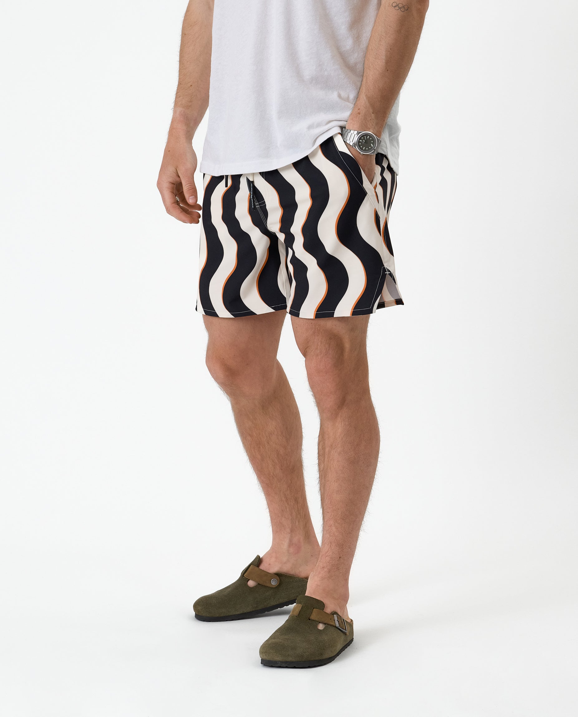 The Shorts in Noir Curl Stripe — worn with a white t-shirt and olive green clogs