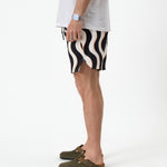 The Shorts in Noir Curl Stripe — side view showing the wavy pattern and notched hem