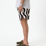 The Shorts in Noir Curl Stripe — side view showing the wavy pattern and notched hem