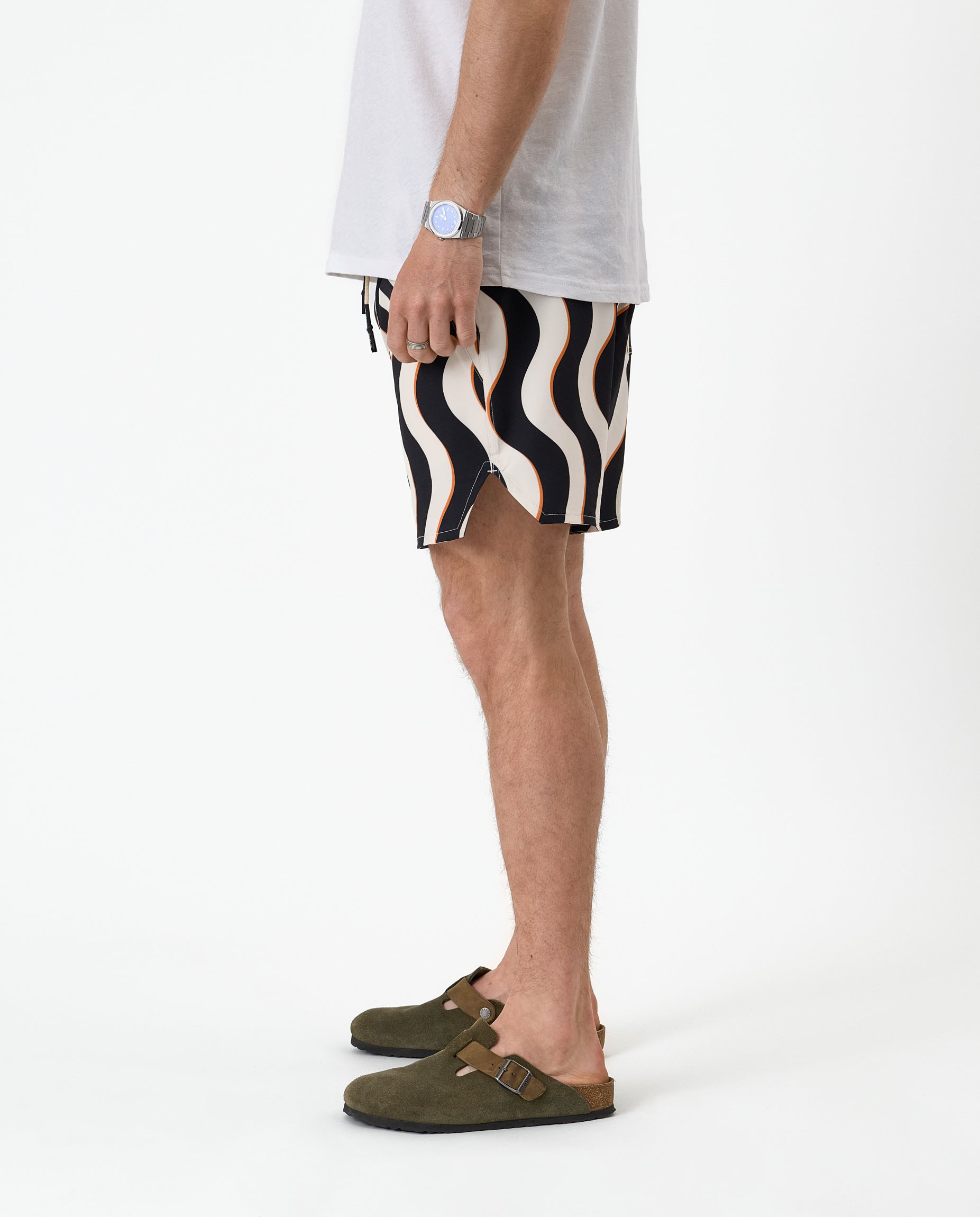 The Shorts in Noir Curl Stripe — side view showing the wavy pattern and notched hem