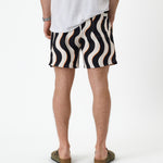 The Shorts in Noir Curl Stripe — back view showing the wavy graphic pattern