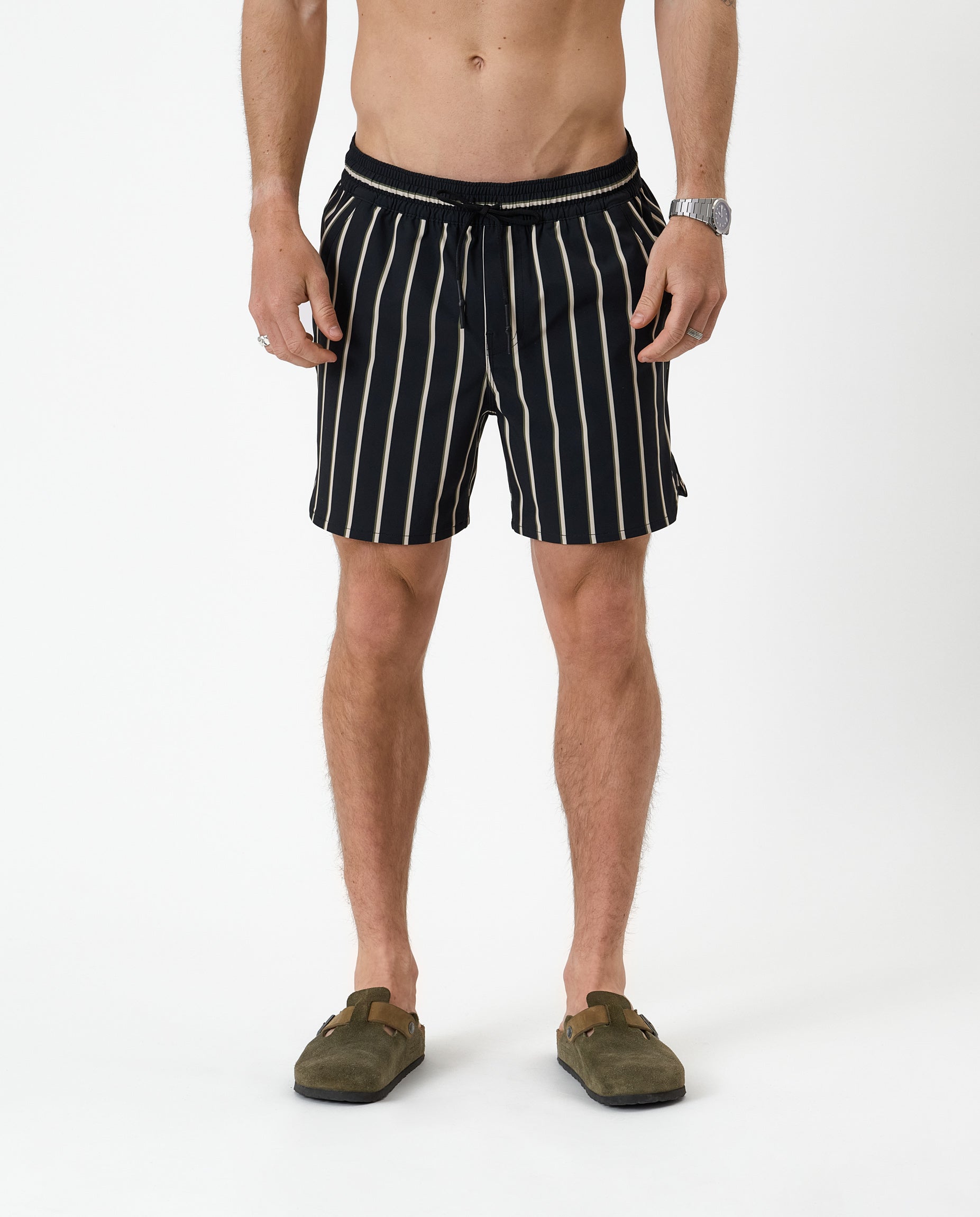 The Shorts in noir stripe — front view worn with olive green clogs