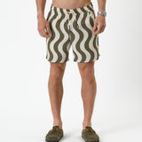 The Shorts in olive curl stripe — featuring a wavy pattern and styled with green clogs