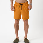The Shorts in orange peel — front view with black drawstring and C'est normal logo