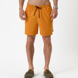 The Shorts in orange peel — front view with black drawstring and C'est normal logo