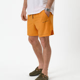 The Shorts in orange peel — worn with olive clogs and a white t-shirt