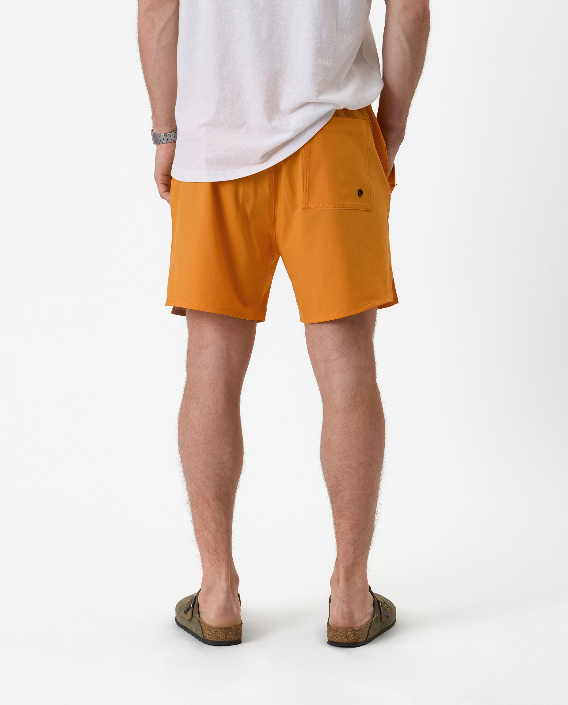 The Shorts in orange peel — back view showing the single rear pocket