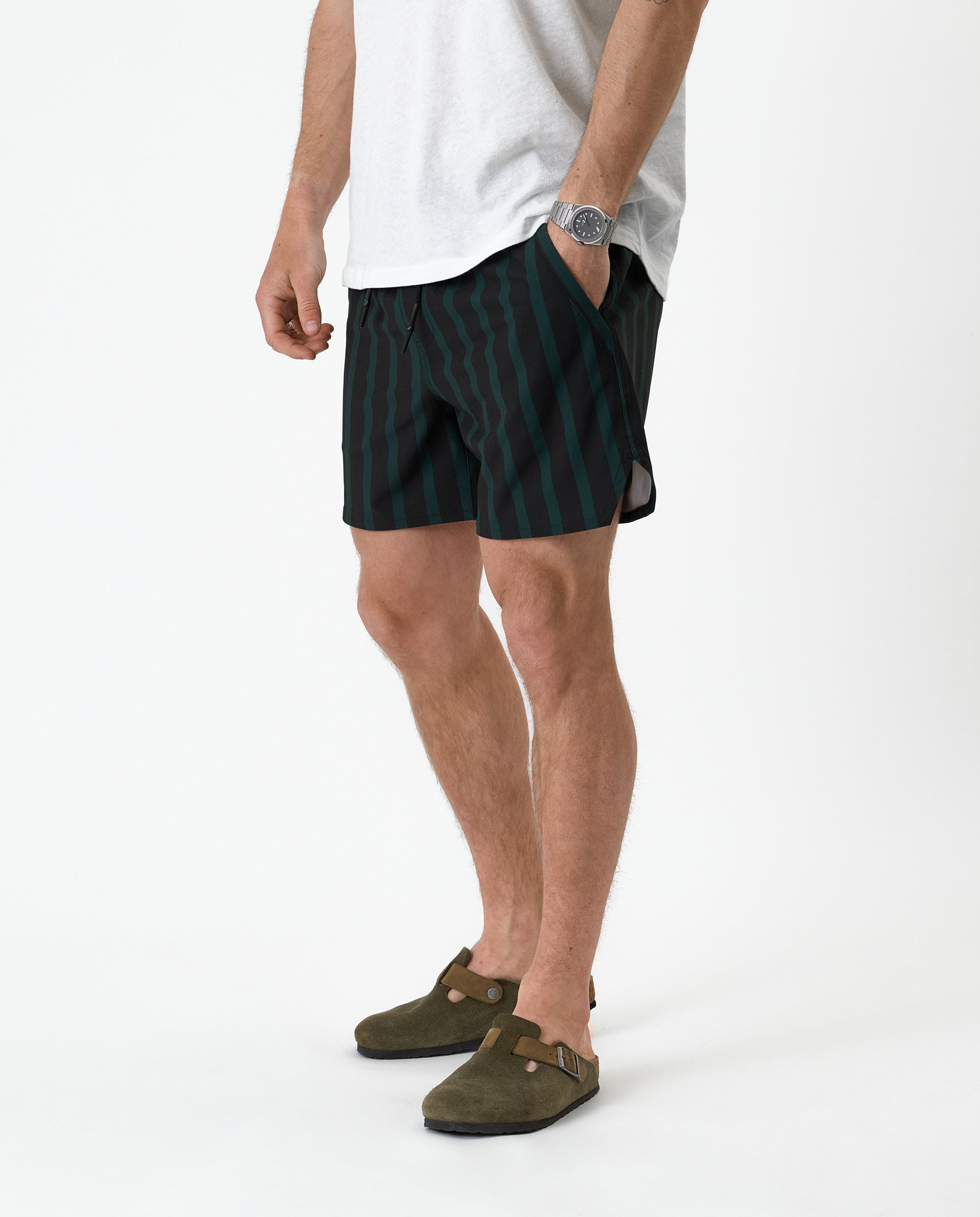 The Shorts in phantom stripe — worn with olive green suede clogs and a white t-shirt
