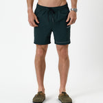 The Shorts in pine — front view worn with olive green clogs