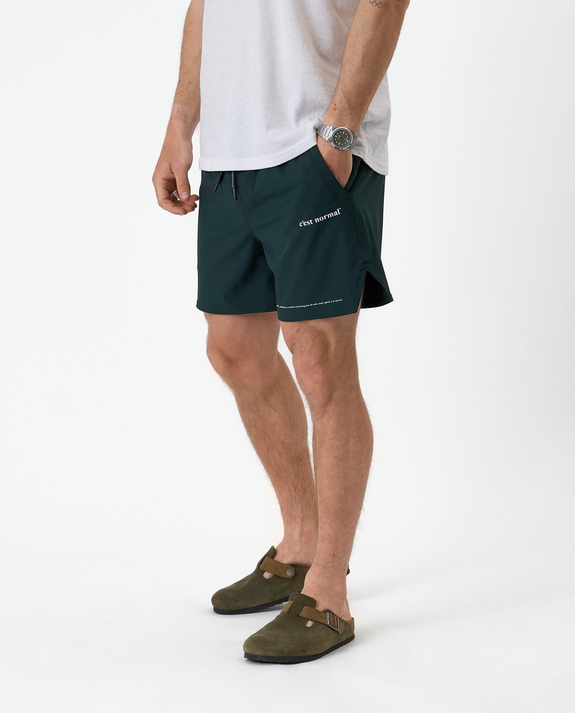 The Shorts in pine — worn with olive green clogs and a white t-shirt