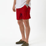 The Shorts in red — worn with olive green clogs and a white t-shirt