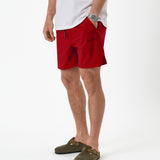 The Shorts in red — worn with olive green clogs and a white t-shirt