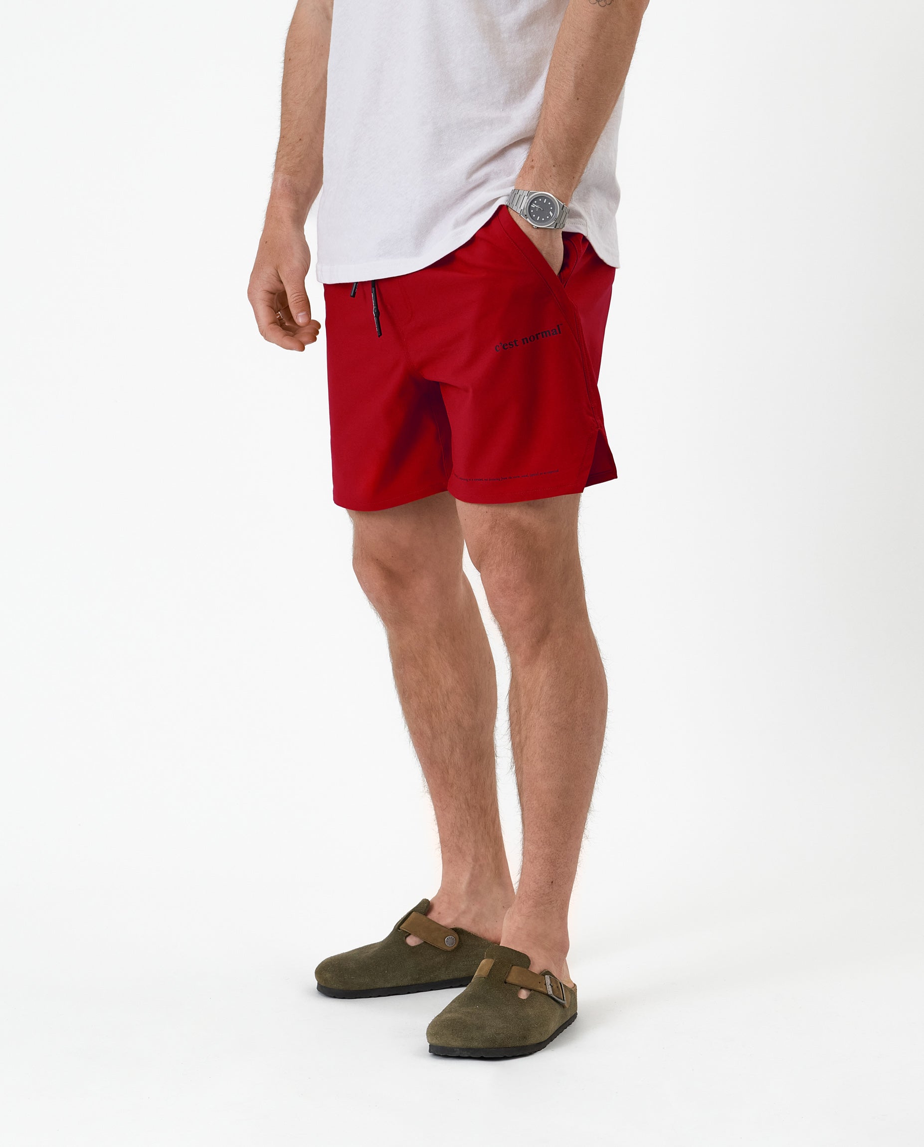 The Shorts in red — worn with olive green clogs and a white t-shirt