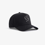 A front angled view of The Snapback Cap in black, resting on a white background. The image highlights the dark embroidered c'est normal mirror logo on the front panel.