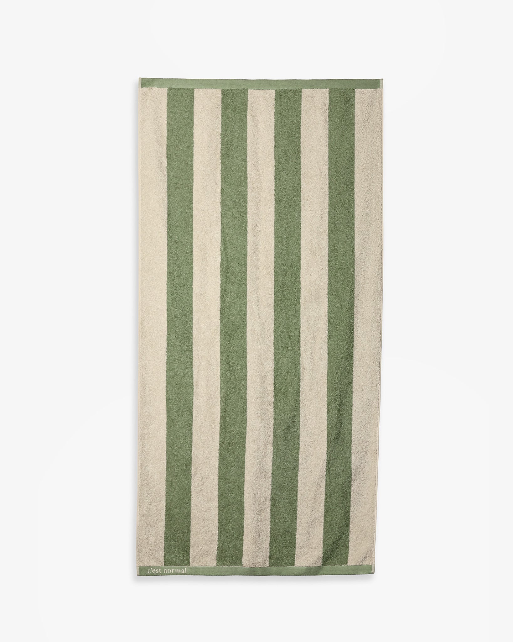 The Lombok Beach Towel in Lombok Stripe — full view showing green and cream vertical stripes