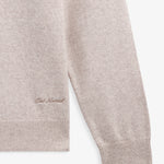 The Toulouse Hoodie in beige — close-up of embroidered C'est normal logo