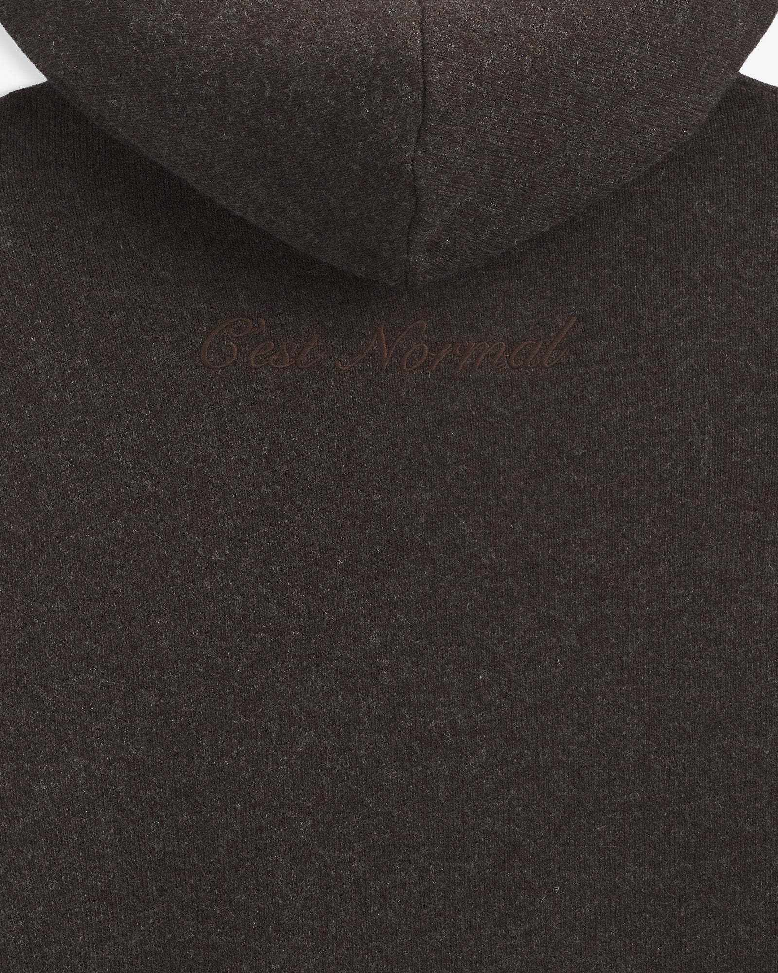 The Toulouse Hoodie in brown melange — close-up of the embroidered C'est normal logo on the back