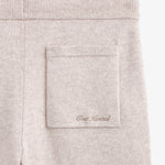 The Toulouse Pant in beige — close-up of the back pocket with C'est normal embroidery