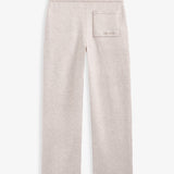 The Toulouse Pant in beige — back view featuring a back pocket with C'est normal branding