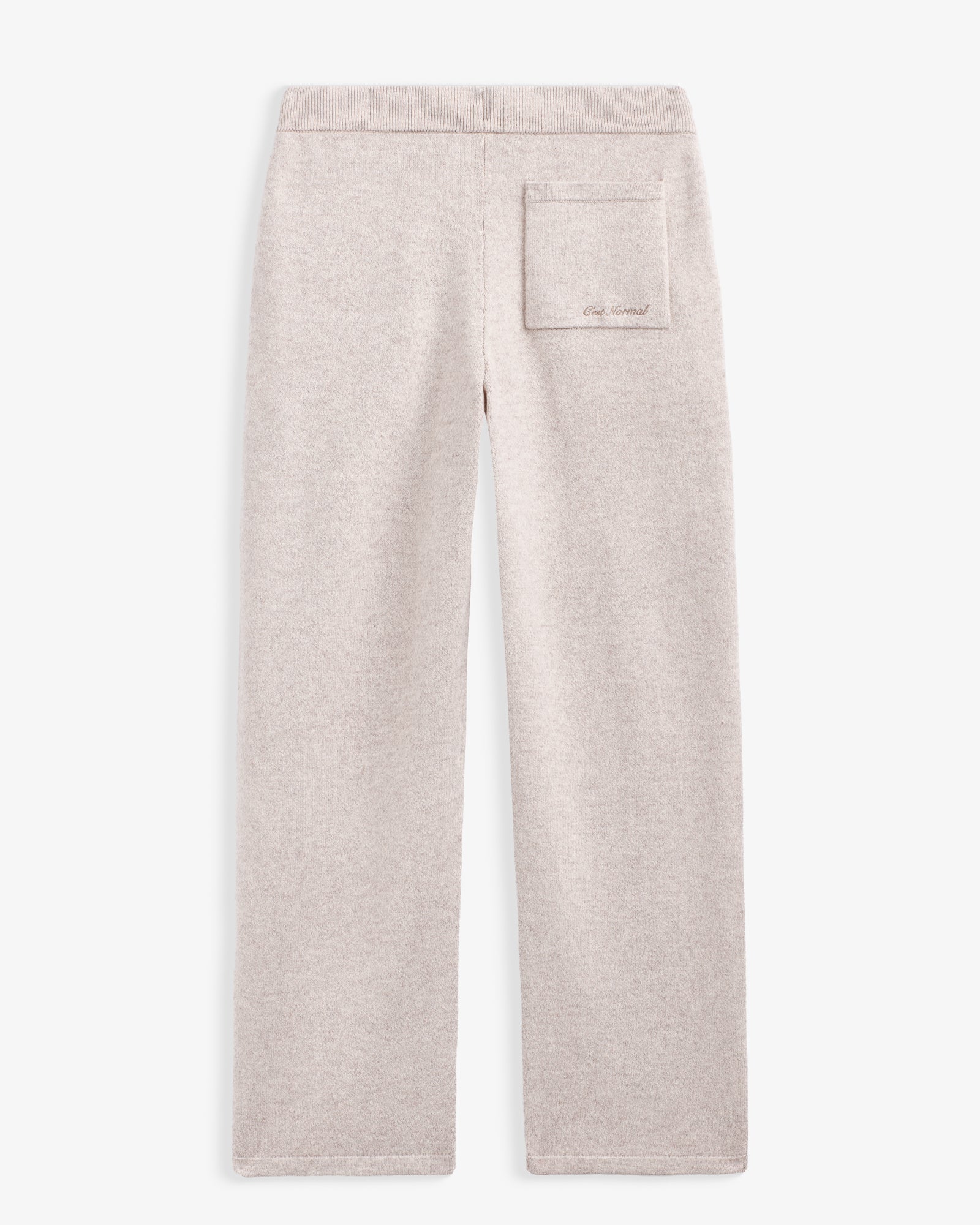 The Toulouse Pant in beige — back view featuring a back pocket with C'est normal branding