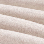 The Toulouse Pant in beige — close-up of the knit fabric texture