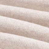 The Toulouse Pant in beige — close-up of the knit fabric texture