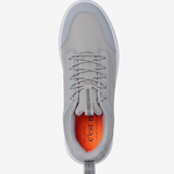 A top-down view of The Dynamic Waterproof Sneaker 2.0 Low in grey, laid flat on a white background. The image highlights the waterproof upper, laces, padded collar, and the bright orange insole featuring the c'est normal logo.