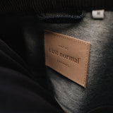 The Denim Jacket in rinse — close-up of the C'est normal neck label