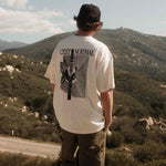 The Oversized Printed T-shirt in cream/black — back view showing the C'est normal cactus graphic