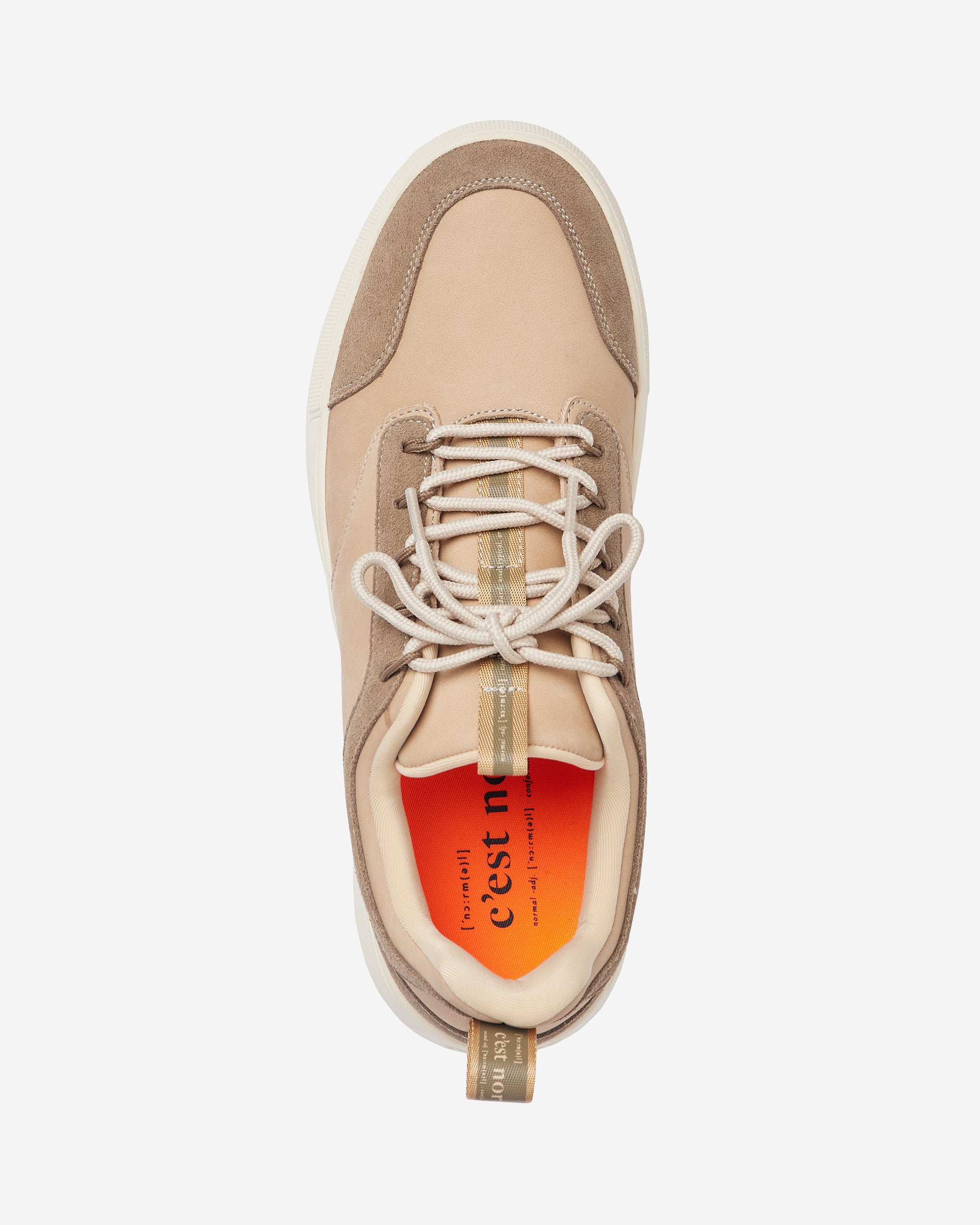A top-down view of The Sneakers 2.0 Leather in Sand Leather, laid flat on a white background. The image highlights the tone-on-tone leather and suede upper, the laces, and the bright orange insole featuring the c'est normal logo.