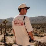 The Oversized Printed T-shirt in cream & red — back view showing the C'est normal desert graphic