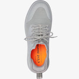 A top-down view of The Sneakers 2.0 in grey, laid flat on a white background. The image highlights the tone on tone mesh upper, custom lace loops, and the bright orange insole featuring the c'est normal logo.