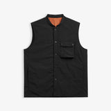 The Utility Vest in black — front view showing the chest pocket and snap button closure