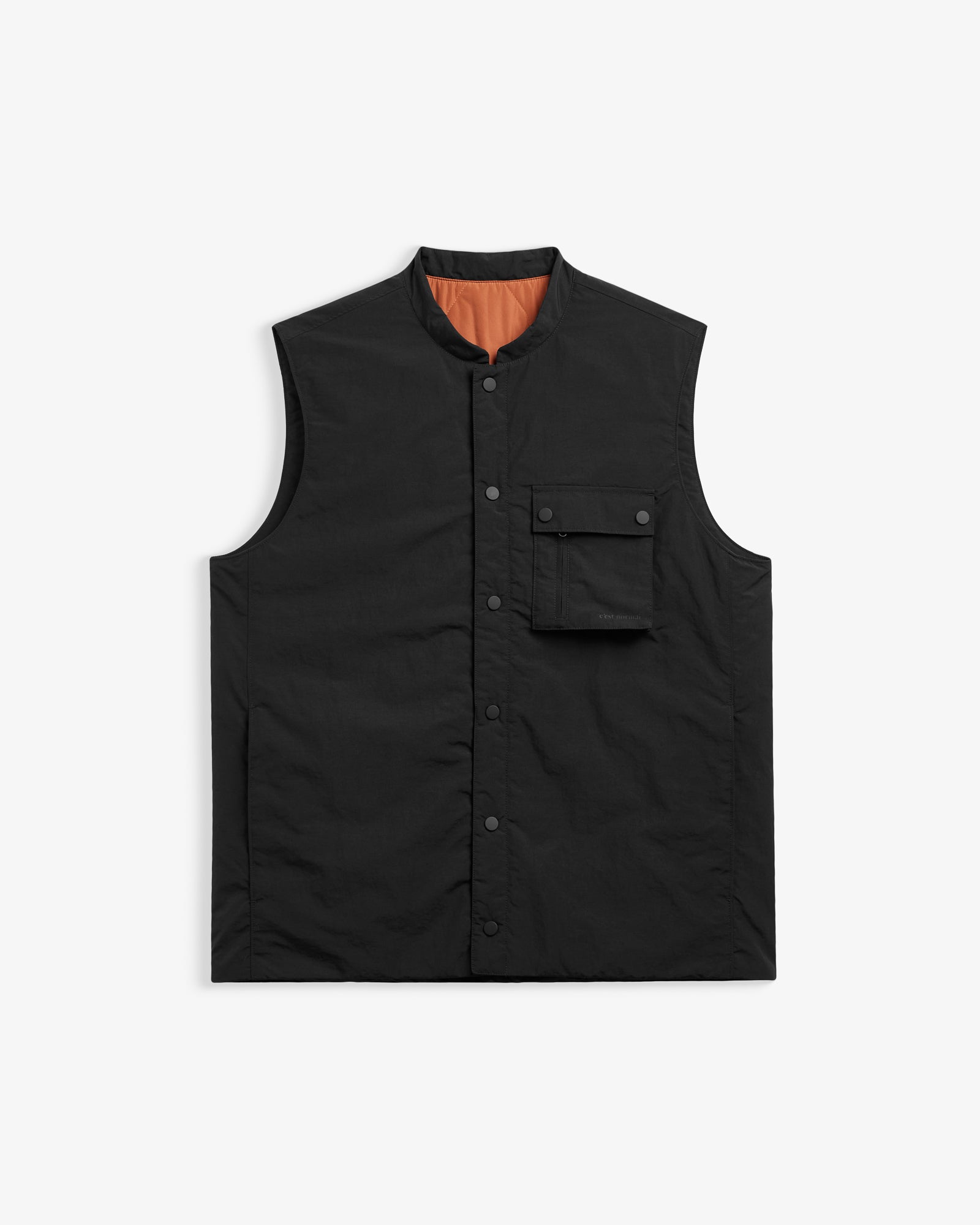 The Utility Vest in black — front view showing the chest pocket and snap button closure