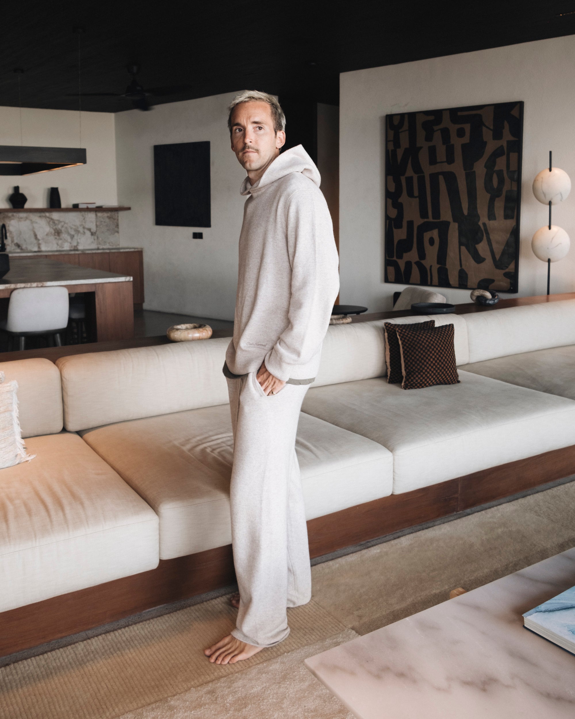 The Toulouse Hoodie and Pant in beige — worn as a matching set indoors