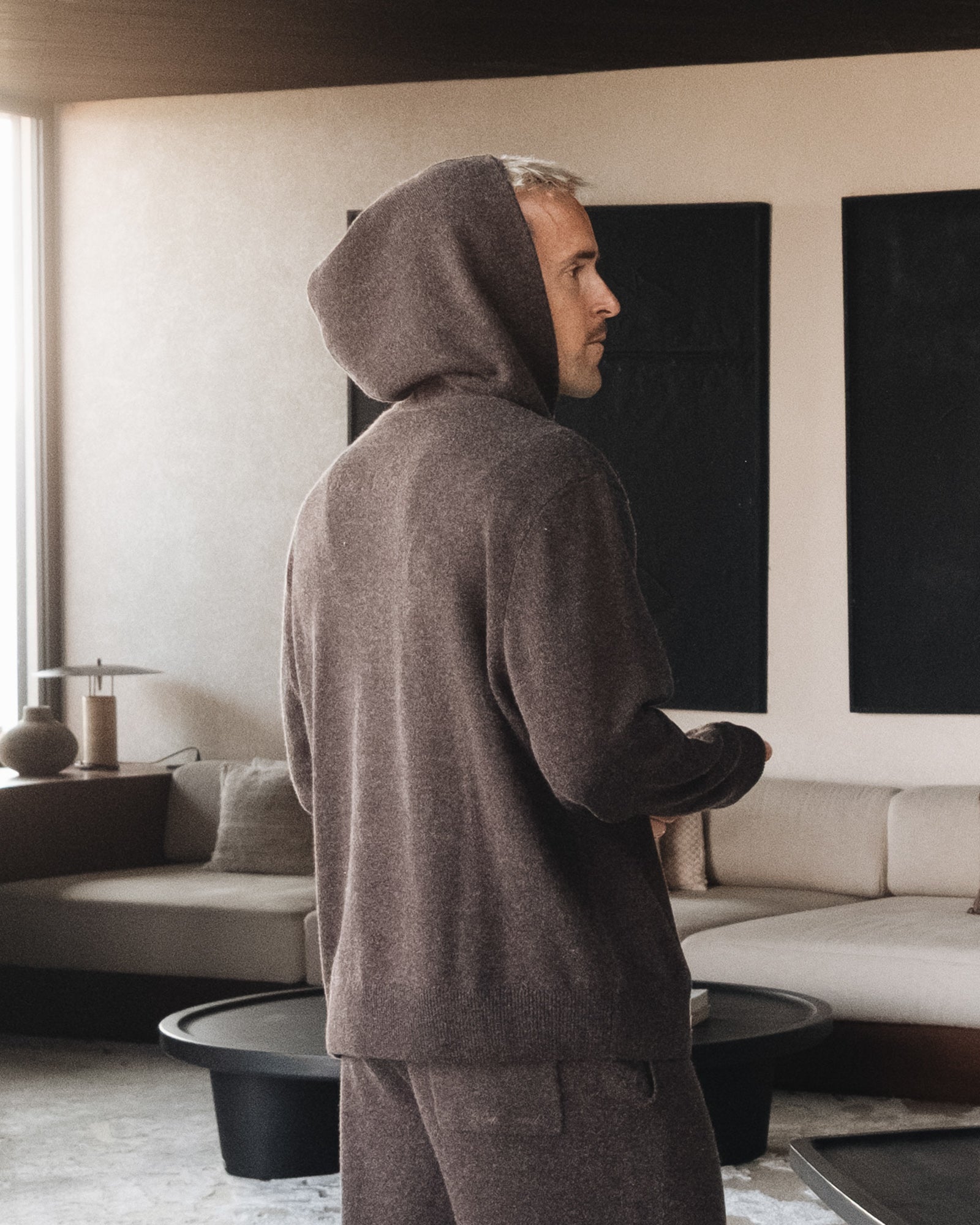 The Toulouse Hoodie in brown melange — back view worn in a lifestyle setting