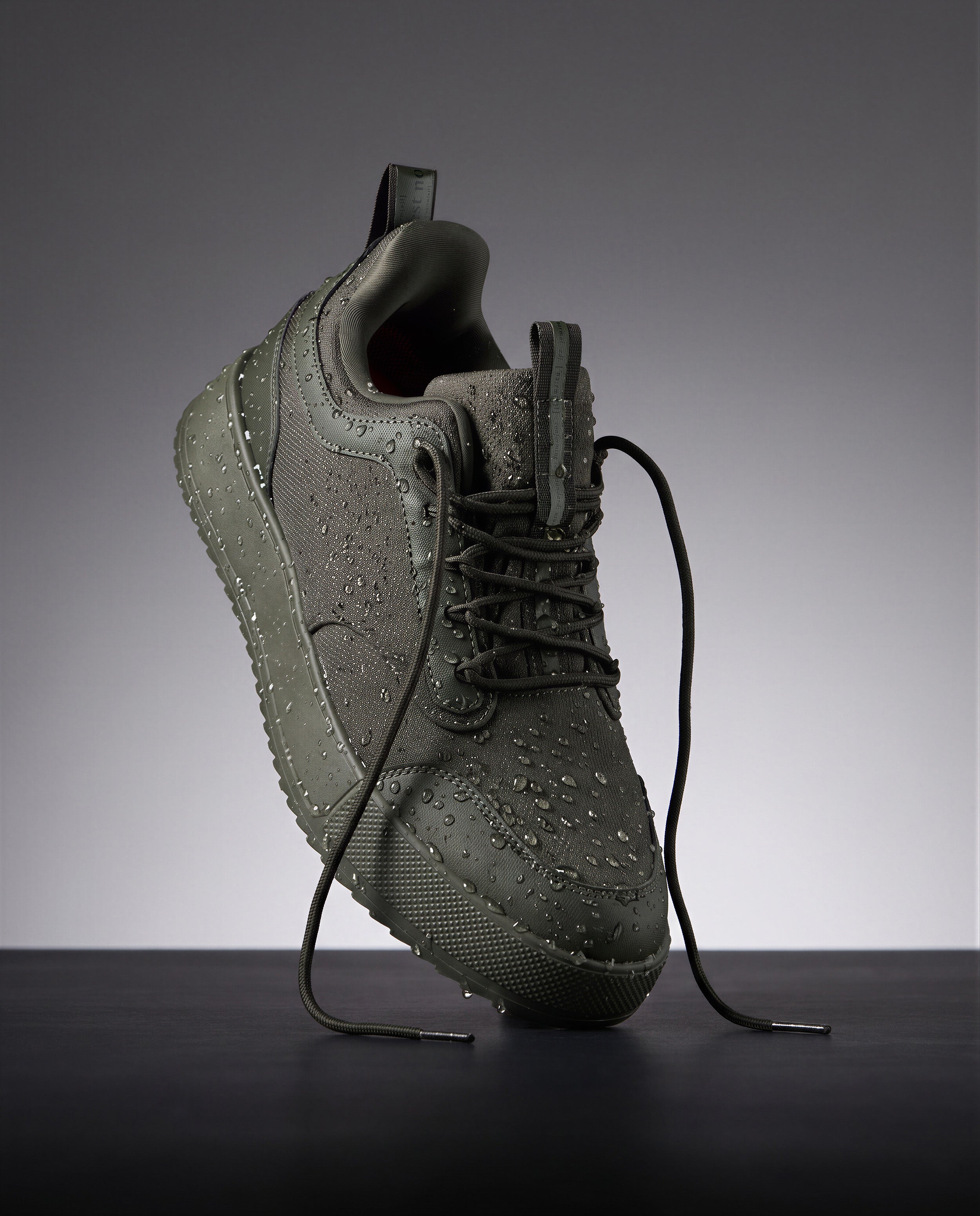 The Dynamic Waterproof Sneaker 2.0 Low in khaki — angled view covered in water droplets