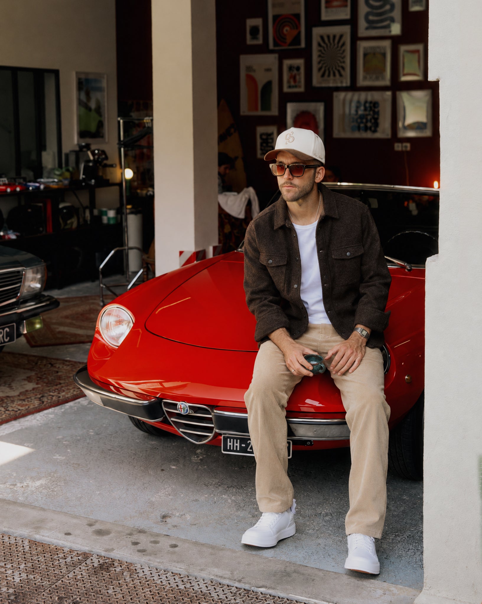 Stockholm Wool Shacket in brown melange — worn while sitting on a red car
