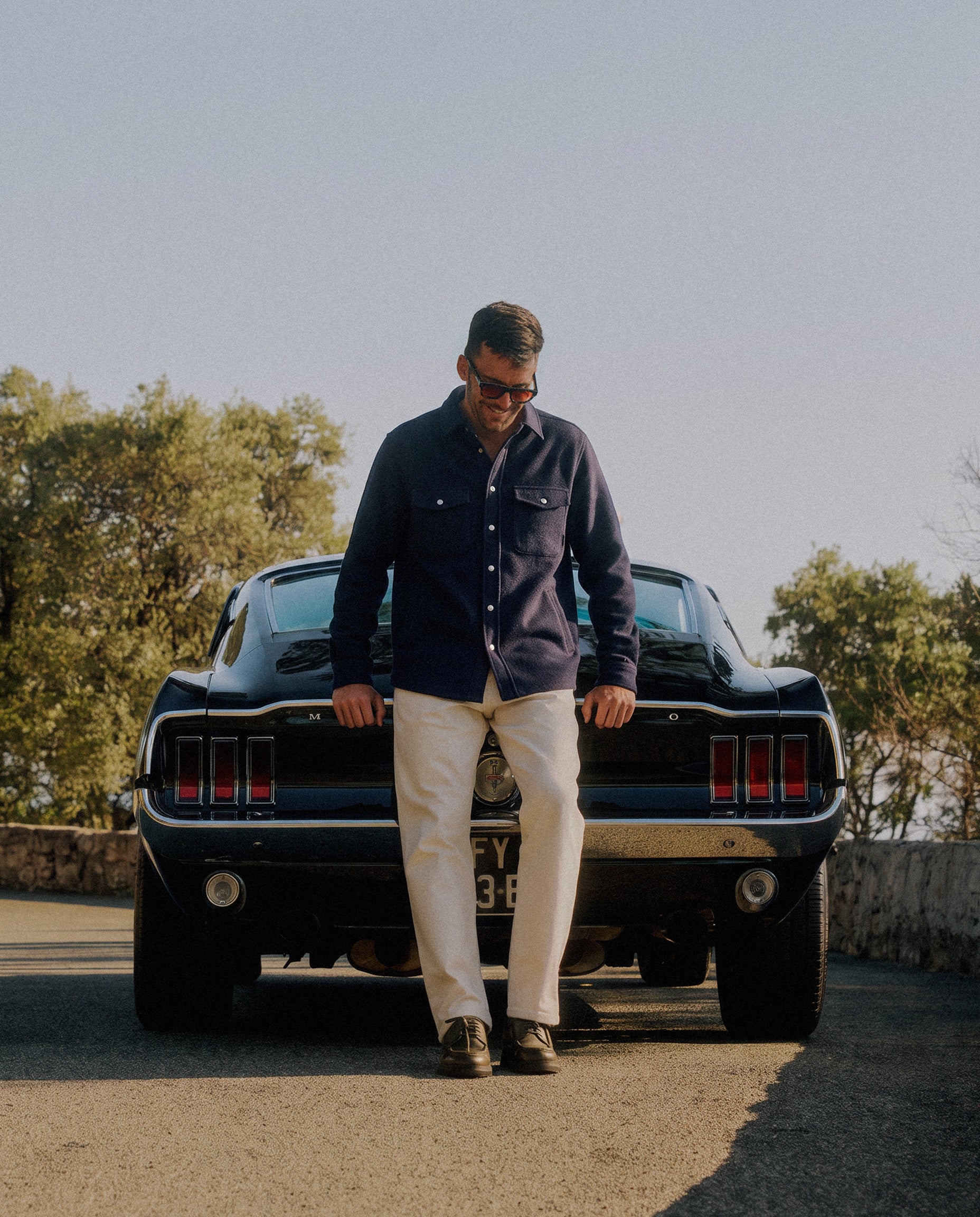Stockholm Wool Shacket in navy — worn leaning against a classic car
